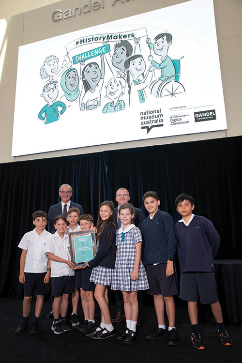 Students from Galilee Catholic Primary School, Bondi, receive their History Makers 2022 prize from Steven Gandel and National Museum director, Dr Mathew Trinca. Photo: National Museum of Australia.